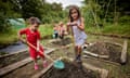 Eva (six) and her brother Axl (four) get to work in the family’s allotment along with Nya (two, in the background), and their mother, Jen Langley.