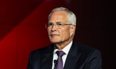 man in suit and tie against a red background