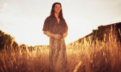 Charlie Gilmour standing in a sunlit wheat field