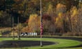 A flag at half-mast near a recycling facility where law enforcement found the body of Robert Card, the suspect in this week's mass shootings.