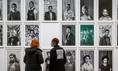 Tate visitors study portraits from the artist’s ongoing series Faces and Phases.