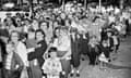 FILE - Parents and children wait outside the Riverside Public School in Elmira, N.Y., on July 1, 1953, to get the polio vaccine, due to the rise in infantile paralysis in Chemung and Steuben Counties. The Centers for Disease Control and Prevention said the polio virus was detected in wastewater samples collected in June 2022 from Rockland County outside New York City. An unvaccinated adult recently contracted the life-threatening disease, but health officials said Tuesday, Aug. 2, 2022, they have not identified additional cases. (AP Photo/Paul E. Thomson, File)