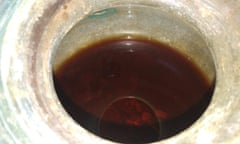 Overhead view of an urn with reddish-brown liquid in it