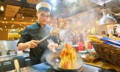 SAINT PETERSBURG, RUSSIA - CIRCA AUGUST, 2017: man expertly prepare the food in wok at Marketplace restaurant.<br>MDNH5E SAINT PETERSBURG, RUSSIA - CIRCA AUGUST, 2017: man expertly prepare the food in wok at Marketplace restaurant.