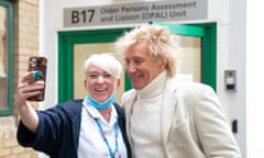 Rod Stewart poses for photos with radiographer Zoe Tiley at the Princess Alexandra hospital in Harlow, Essex.