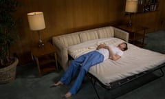 Man lying on sofabed<br>GettyImages-82836843