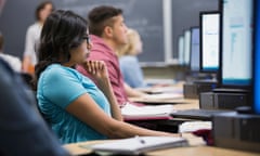 Students studying at computers in classroom