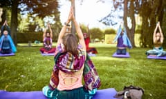 Yoga teacher taking yoga class in park