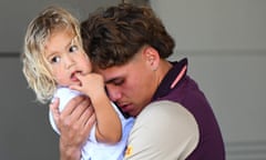 Broncos fullback Reece Walsh with daughter Leila on his arrival at Brisbane airport on Monday