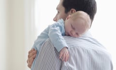 Father holds baby on shoulder