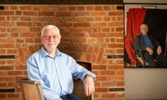 Davies before the fireplace, with his portrait visible in the background