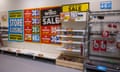 Discount signs and empty shelves inside a Wilko store