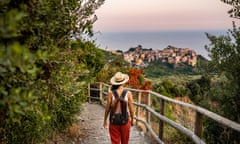 Discovering Italy.<br>Female backpacker tourist walking towards Corniglia village, Beautiful town in Cinque Terre coast