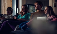 A family relaxing in front of the TV