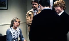 Gwyneth Powell as Bridget McClusky in Grange Hill, with Brian Capron as Mr Hopwood, Mark Savage as ‘Gripper’ Stebson (back to camera) and  Peter Moran as ‘Pogo’ Patterson.