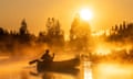 golden light on lake and canoe