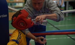 A young boy in a boxing ring.