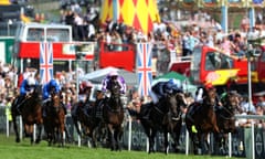 Racegoers at Epsom watch Wings Of Eagles heading for Derby victory