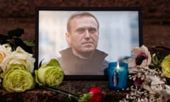 flowers surround a portrait of Alexei Navalny