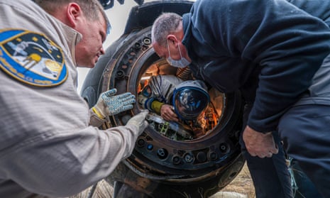 Astronaut and cosmonauts return to Earth after getting stuck in space for 371 days – video