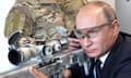 Russian President Vladimir Putin aims a sniper rifle at a military exhibition.
