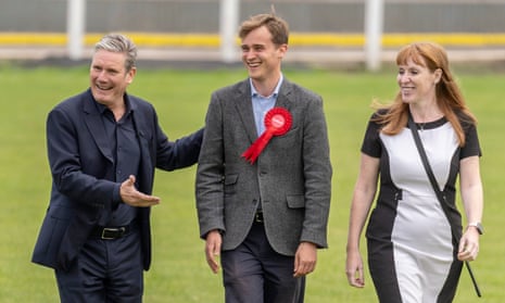 Keir Starmer and Angela Rayner smile as they stand either side of Keir Mather.