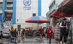 Palestinian families take refuge at a school affiliated with the UNRWA in Gaza City