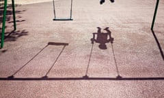 Shadow of a child on a playground swing<br>Shadow of a child on a playground swing - stock photo