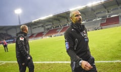 Helsingborg's soccer club manager and coach Henrik Larsson, right, leaves the pitch after losing the match against against Halmstad in Helsingborg, Sweden Sunday Nov. 20, 2016. Swedish officials are considering tougher measures against hooligans after Helsingborg supporters stormed the field and attacked Henrik Larssons son after the team was relegated from the top division in Sweden. (Emil Langvad / TT via AP)