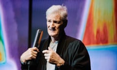 James Dyson holds an appliance on stage