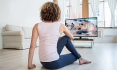 Fit woman exercising at home watching a DVD<br>Posed by model Fit African American woman exercising at home watching a DVD - healthy lifestyle