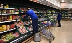 Supermarket staff at work in London.