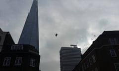 The Base jumper floats to the ground after opening his parachute. 