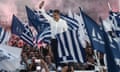Kyriakos Mitsotakis waves to supporters. He is surrounded by blue-and-white flags