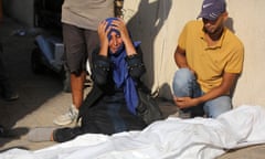 Mourning Palestinians at Al-Aqsa Martyr's Hospital in Deir al-Balah, Gaza.