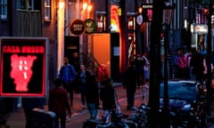 NETHERLANDS-HEALTH-VIRUS-PROSTITUTION<br>People walk along a street of the red light district in Amsterdam on July 1, 2020, as Dutch brothels reopened today after a long coronavirus shutdown, with sex workers and clients having to observe new rules to prevent COVID-19 infection. - The Netherlands ordered all sex clubs closed in mid-March and had originally planned to keep them closed until September, but recently brought the date forward as COVID-19 cases dropped. (Photo by Kenzo TRIBOUILLARD / AFP) (Photo by KENZO TRIBOUILLARD/AFP via Getty Images)