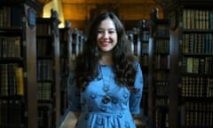 kiran millwood hargrave standing in a library