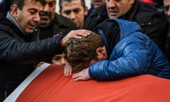 Relatives of Ayhan Arik, one of the victims of the Reina nightclub attack, mourn during his funeral