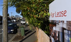 residential street with a 'For Lease' sign displayed outside a house