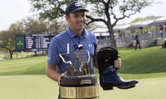 Jordan Spieth stands with the Valero Texas Open trophy and the boots awarded to the champion