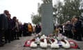 Floral tributes are laid at the memorial garden overlooking the railway line at Ladbroke Grove on the 20th anniversary of the rail disaster.