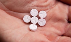 Ecstasy pills or tablets in a mans hand