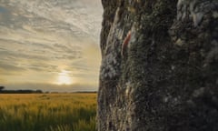 Still for A Year in a Field looking from the rock across a crop field towards the sun sitting low on the horizon