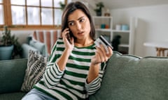 Concerned woman talking on smartphone having finance stolen from card