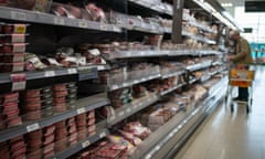 A shopper in the fresh meat section of a Waitrose supermarket