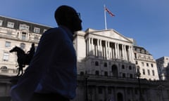A man is silhouetted in front of the Bank of England