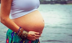 A pregnant woman holds her belly