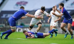 Tom Curry leaps over the challenge of Antoine Dupont during a man-of-the-match display for England against France