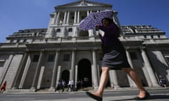 Pedestrians walk past Bank of England