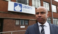 Sanjeev Gupta in a suit and tie standing outside a building with a sign on it saying Liberty Steel.